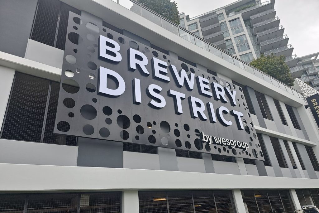Metal Sign reading "Brewery Dstriict by Wesgroup"
