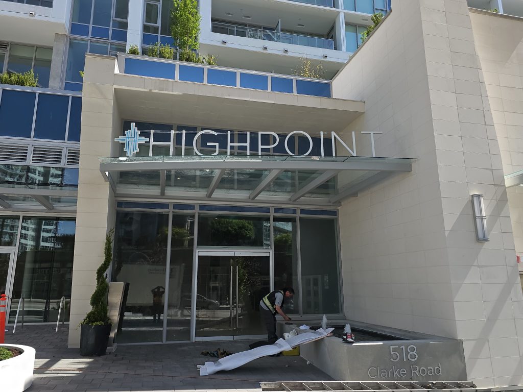 Metal sign above building entrance  reading "Highpoint" 